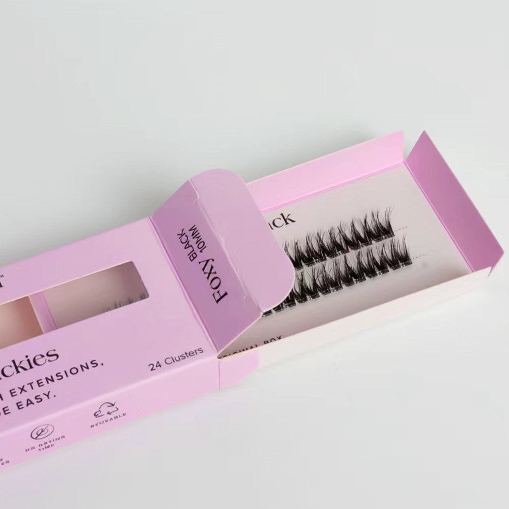 Pink box of false eyelashes with a clear window on a light gray background