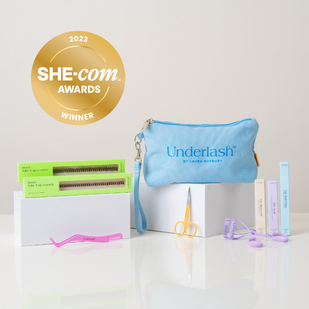 Underlash product set with a blue pouch, scissors, and other items on a white background, featuring the SHE-com Awards 2023 winner badge.