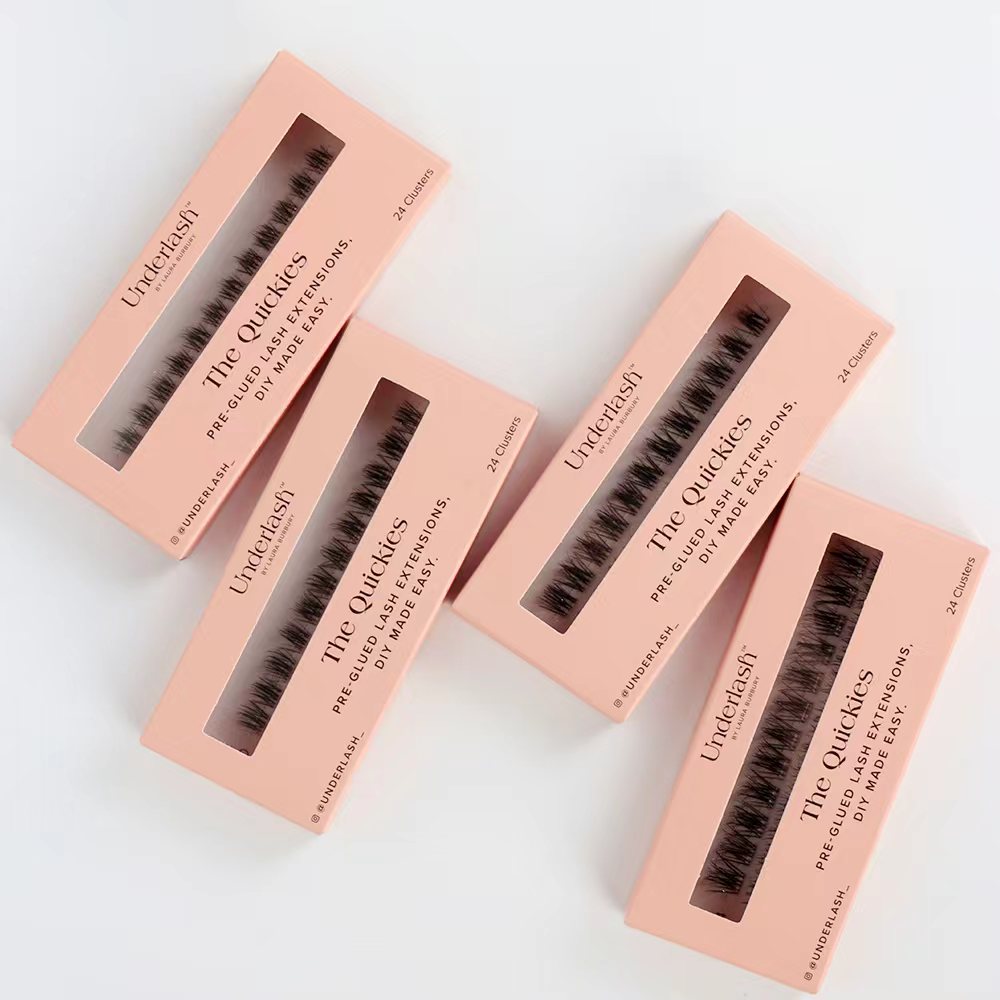 Four boxes of Undereyes The Quickies eyelash extensions on a light gray background