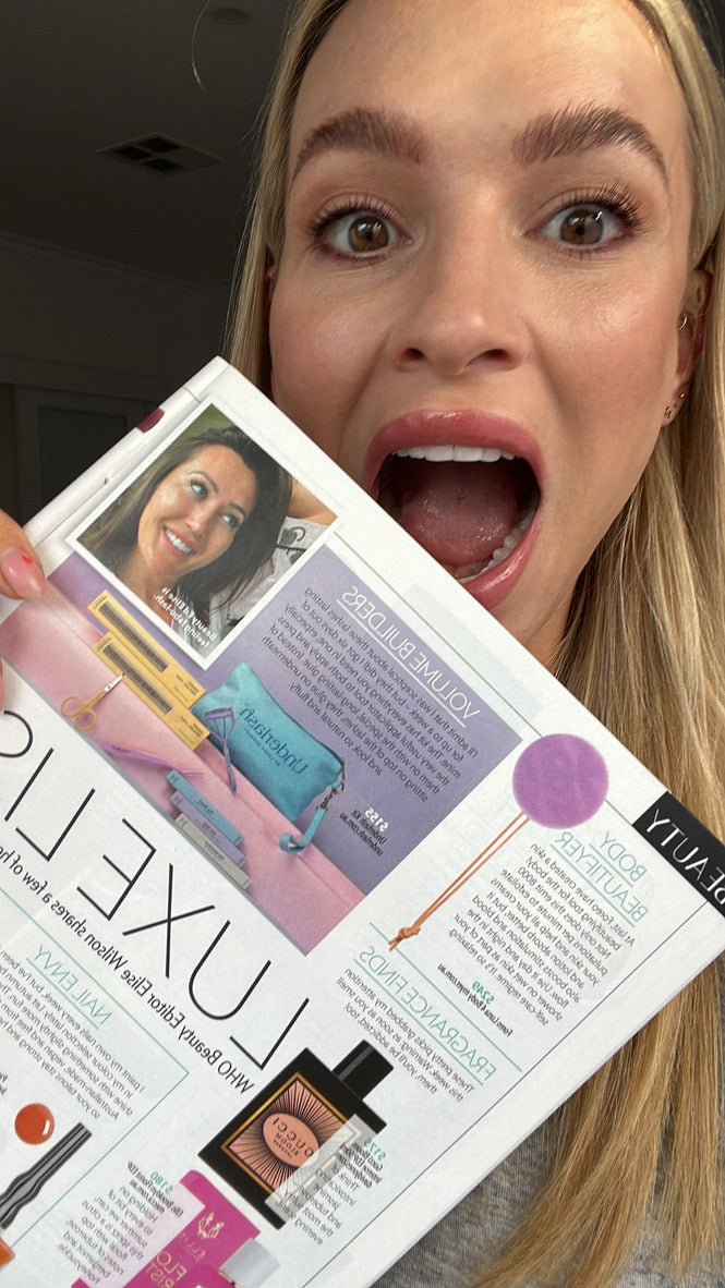 Laura holding the WHO magazine Luxe List page featuring Underlash