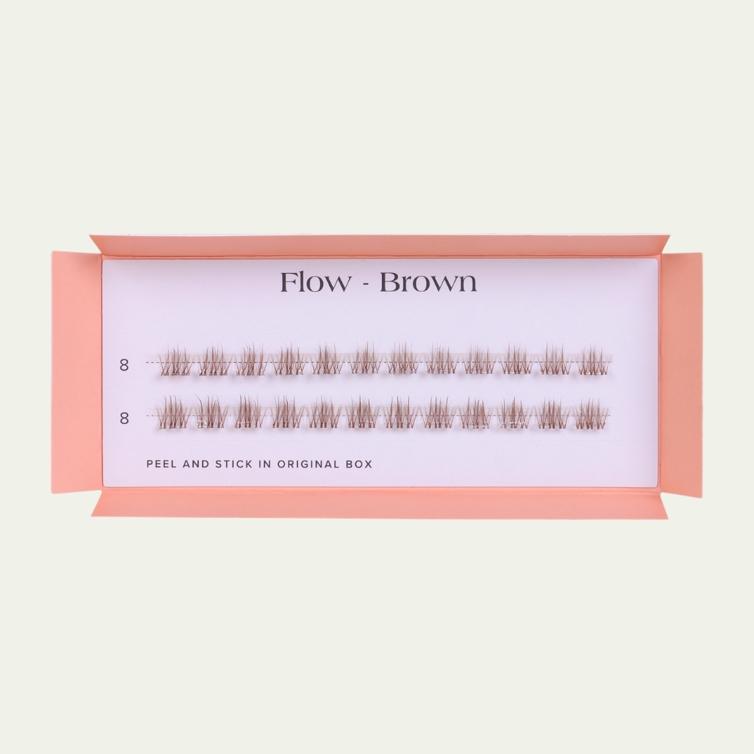 Box of false eyelashes labeled 'Flow - Brown' on a light beige background