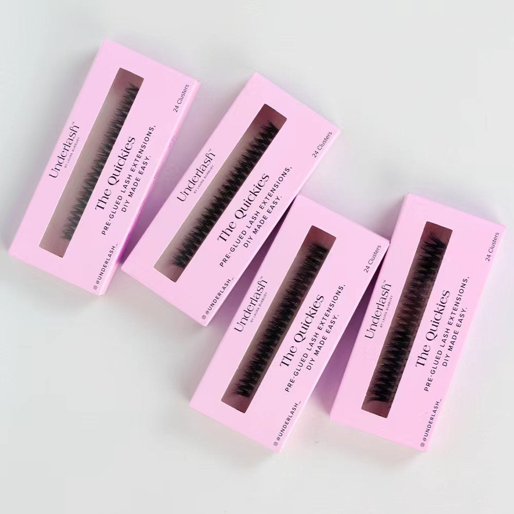 Four boxes of 'The Quickies' eyelash extensions on a light gray background