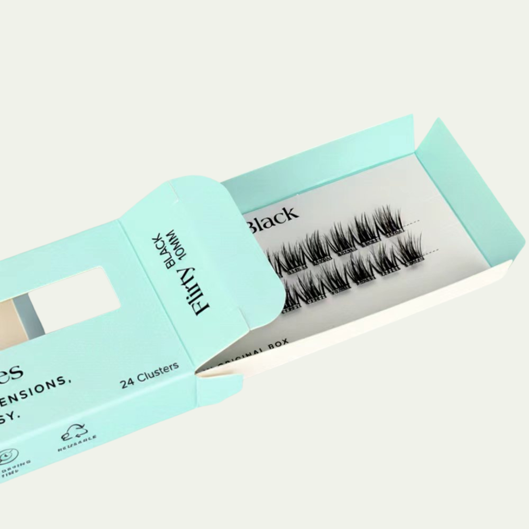 Eyelash extensions in a blue box on a light gray background