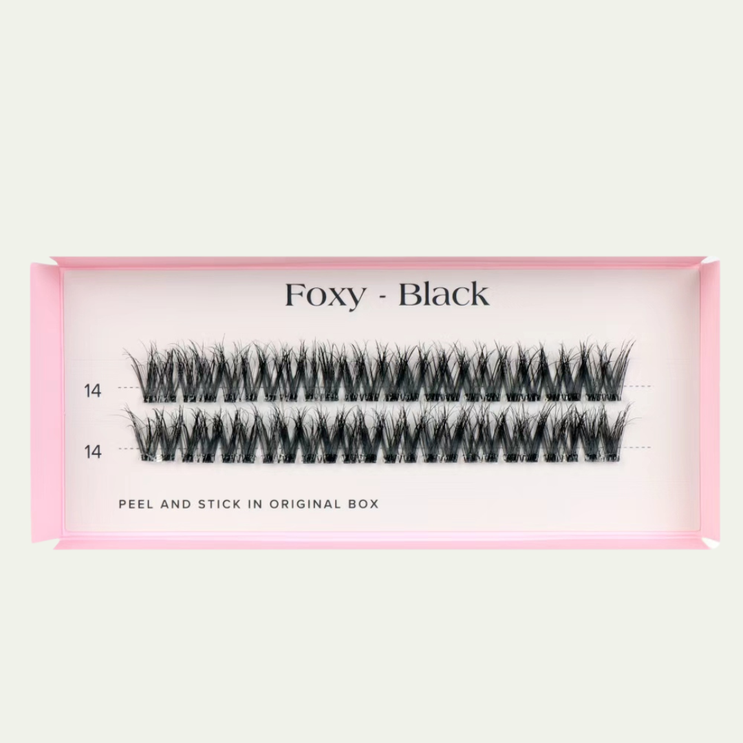 Faux eyelashes in a pink packaging box on a light gray background