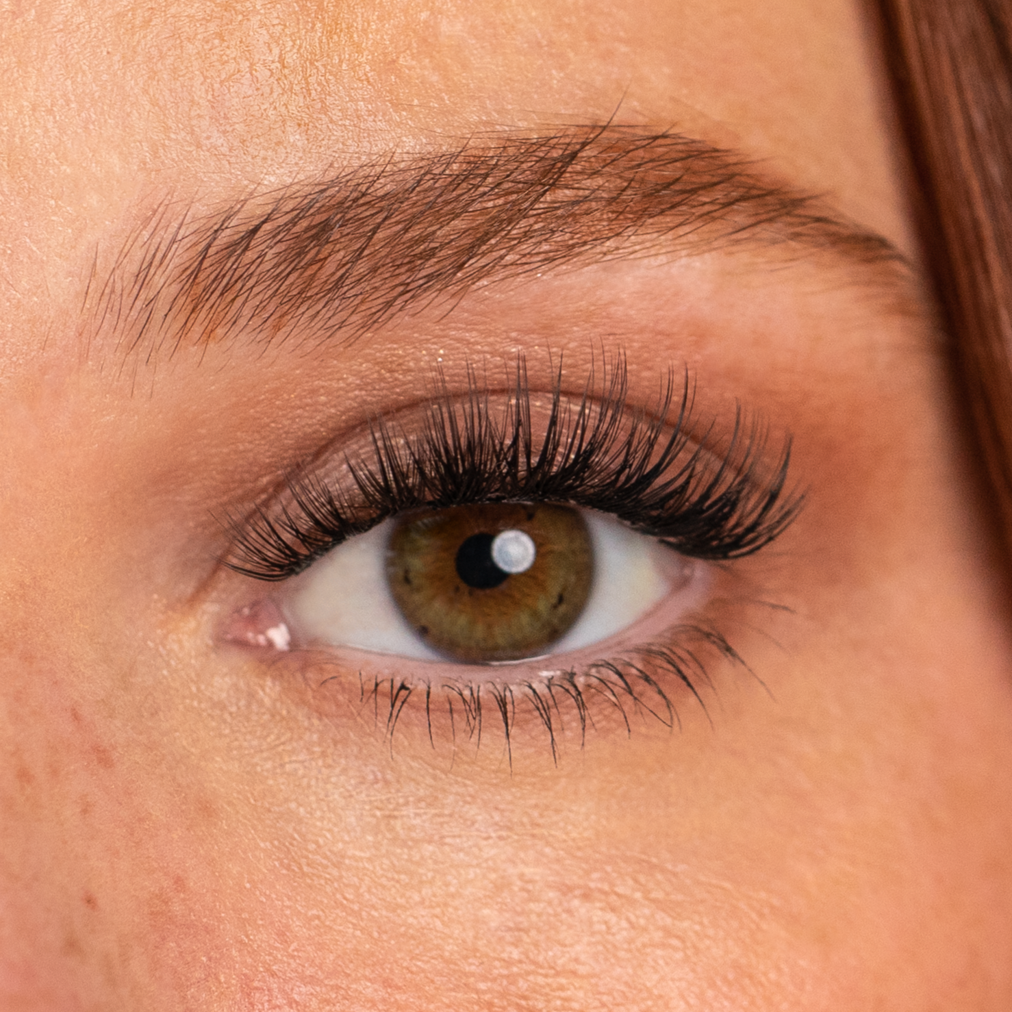 A close up picture of a women wearing lash DIY lash extensions in the style "Mood lashes"